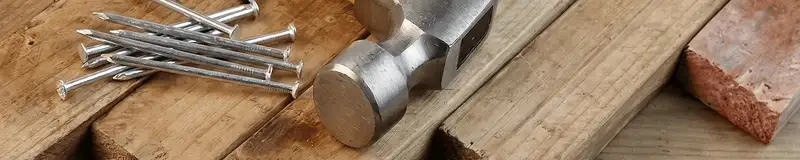 Hammer and nails on hardwood flooring boards in Charleston, SC
